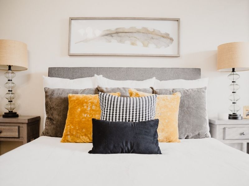 Staged bedroom with layering pillows and different textures to create magazine-worthy photo