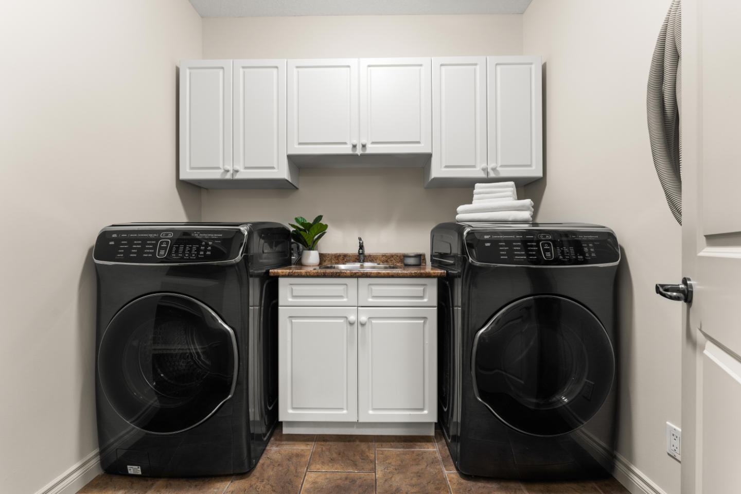 Occupied home staging in Stony Plain laundry room by MacPhee Interiors