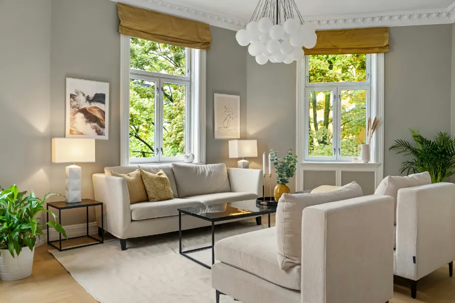 A calm living space with yellow fabric blinds, beige furniture, and similar yellow accents.