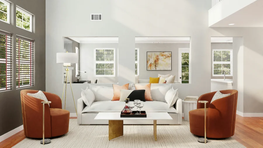 Bright living room with views into the next room, accent pillows and a coffee table with wine decanter and glasses sit in front