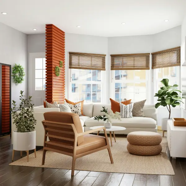 Bay windowed sitting room with white and beige furniture and burnt orange feature wall near the entryway.