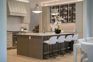 Modern kitchen island with white bar stools.
